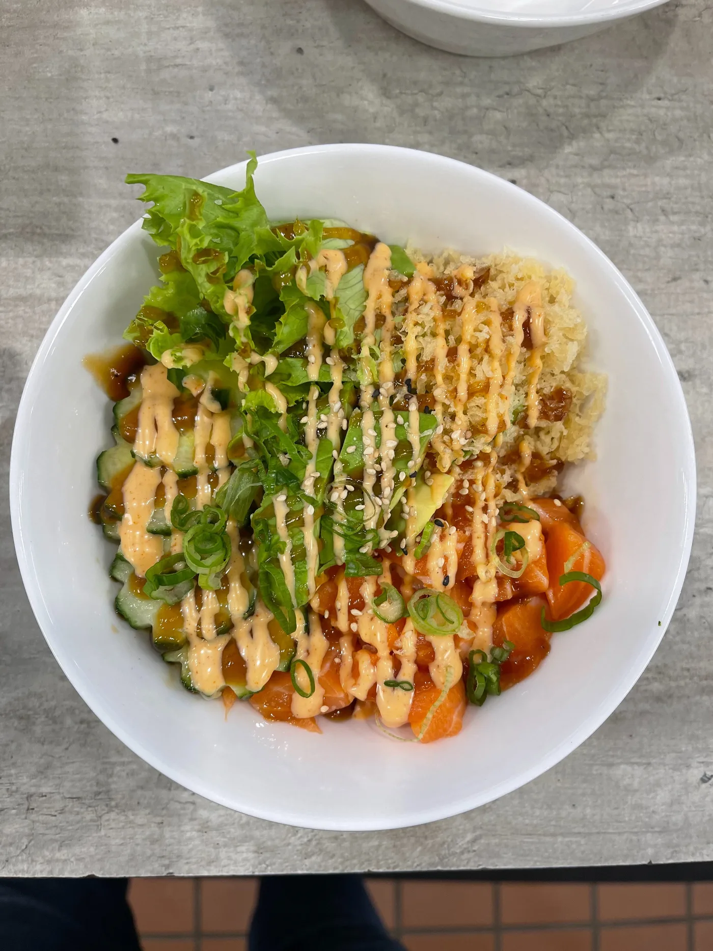 A Salmon Crunch Bowl with fresh salmon, avocado, cucumber and panko under spicy mayo